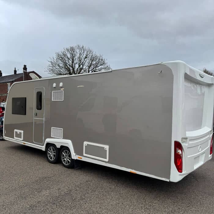 Pristine finish on a large-scale specialist coachwork project. A twin-axle caravan featuring a flawless, high-gloss grey and white respray, demonstrating our professional paintwork capabilities in the PR5 area.
