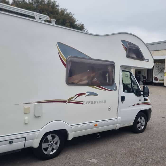 Specialist motorhome paintwork on a large white coachbuilt 'Lifestyle' model. Expert application of decals and graphics following a professional motorhome respray in the PR5 area.